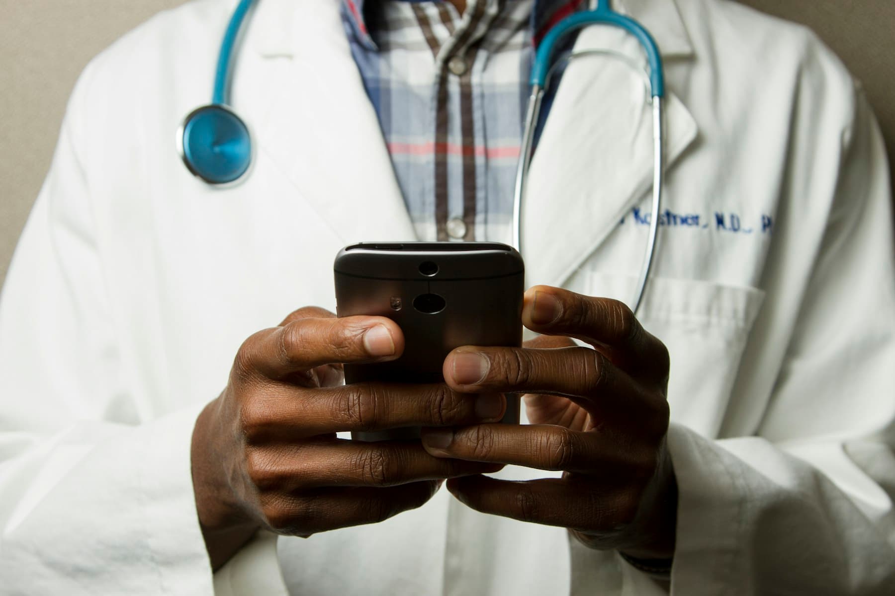 A doctor using a phone during hospital work